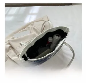 Detail of spacious tote bag interior showing capacity for umbrella and daily essentials