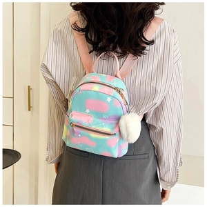 Mini macaron gradient backpack with stars print and plush ball charm shown on a model
