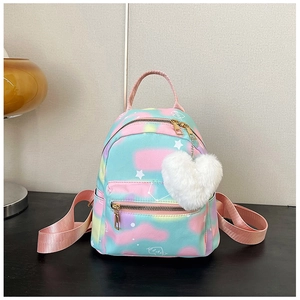Detailed view of dreamy tie-dye mini backpack with star patterns and heart plush charm