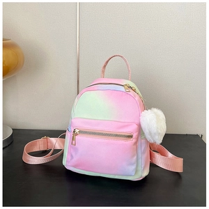 Detail of gradient mini backpack with pink plush pompom charm and gold zippers