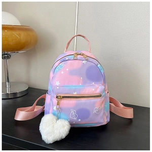 Macro shot of gradient mini backpack with heart patterns and plush heart pendant accessory
