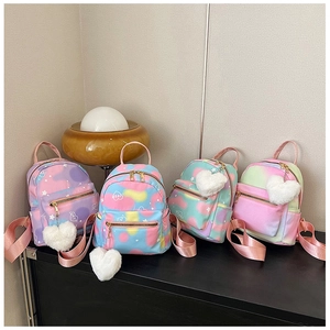 Detail of four gradient mini backpacks with heart prints and white plush charms