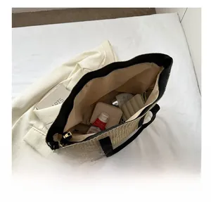 Internal view showing the large capacity and beige woven texture of this tote bag
