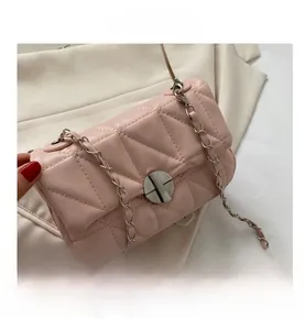Detailed macro view of pink quilted PU leather bag with silver metal swivel lock