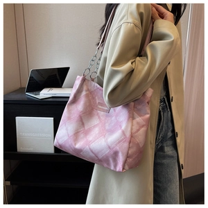 Close-up of pink quilted tote bag with chain strap and Fashion & Bags square label
