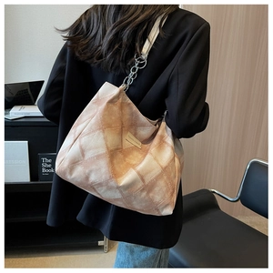 Detail of vintage pink plaid tote bag with silver chain strap on fashion shoulder