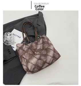 Detail of coffee brown tote bag with quilted texture on grey blazer with props