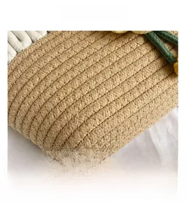 Close-up of woven cotton rope texture and green plant ornaments on beach bag