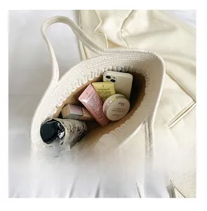 Interior view showing the large capacity of the white woven cotton shoulder bag