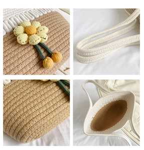 Detail of large woven tote bag with contrast stitching and crochet flower charm accessory