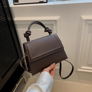 Dark brown retro crossbody handbag with decorative knot handle and magnetic flap