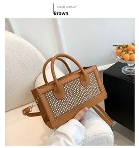Detail of brown rhinestone evening handbag with circular handle and elegant shoulder strap