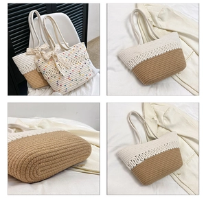 Close-up of woven straw tote bag with colorful pom-poms and white lace bow detail