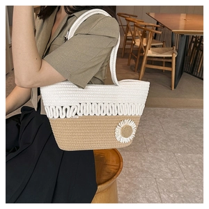 Detail of hollow woven cotton shoulder bag with white 3D daisy and brown contrast trim