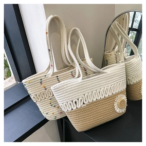 Detail of woven cotton shoulder bags with floral and polka dot patterns for beach