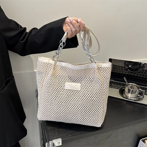 Chic woven beige tote bag with chain strap for commuting and office outfits