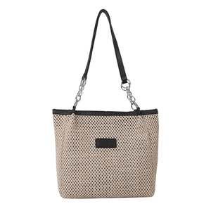 Chic woven tote bag with ivory mesh texture and black leather shoulder straps