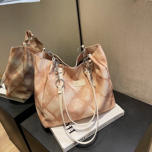 Chic checkerboard tote bag with chain strap and elegant orange-brown patterns