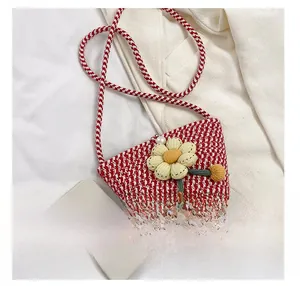 Mini floral woven crossbody bag shown next to a smartphone for size comparison