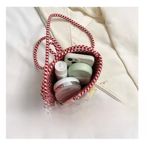 Detail presentation showing the capacity of a red and white woven mini bucket bag