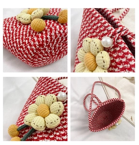 Detailed close-up of woven bucket bag featuring yellow plush flower and pearl clasp detail