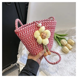 Detail of red and white woven bucket bag with 3D yellow flower and pearl button