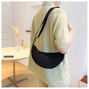 Nylon crescent crossbody bag side view showing the fit and drape on model's body