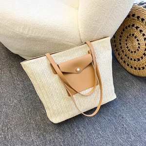 Large capacity woven straw tote bag with brown leather pocket and pearl detail