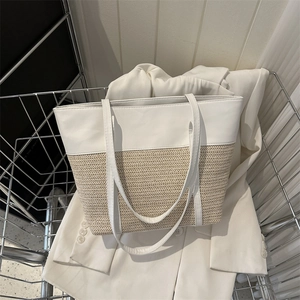 Minimalist straw and white leather tote bag in a metal shopping basket for summer