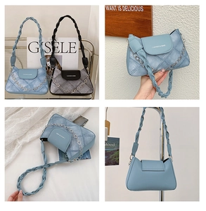 Detail view of quilted shoulder bag featuring woven handles and floral chain accents