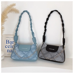 Detail of denim quilted underarm bags in light blue and grey with woven handles