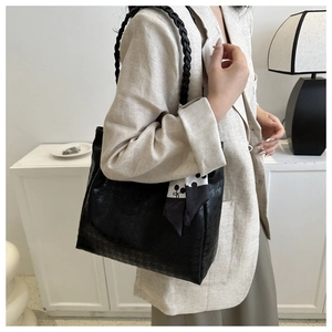 Detail of black houndstooth tote bag with woven strap and silk scarf for commute