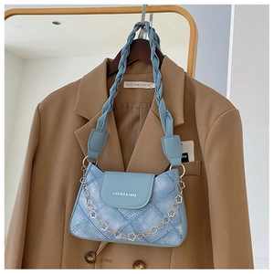 Light blue denim texture shoulder bag with woven strap and gold floral chain detail