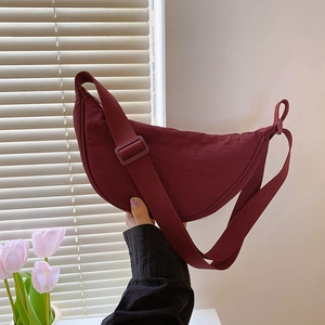 Chic burgundy crescent crossbody bag with adjustable wide strap for summer casual wear