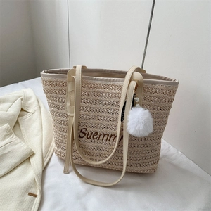 Fashionable woven straw tote bag with Suemmn embroidery and plush ball charm accessory