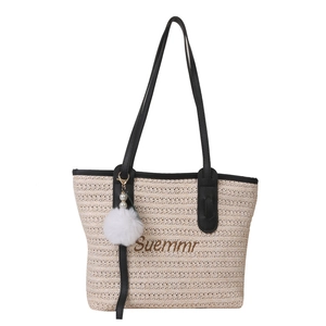 Fashionable straw tote bag with black handles and Summer embroidery on white background
