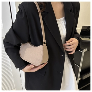Detail of beige felt hobo bag with geometric stitching and golden metal buckle