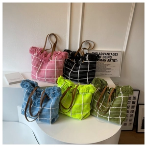 Detailed display of five colorful woven tote bags with stylish fringe and leather handles