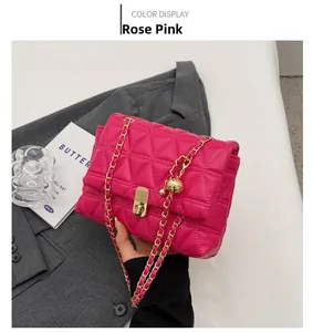 Detail of rose pink quilted chain bag with gold sphere charm and metal twist lock