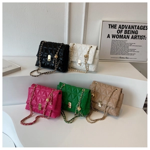 Close-up of quilted crossbody bags in five colors with gold chain straps on display