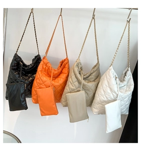Quilted bucket bags in black, orange, cream, and white with chain straps and inner pouches