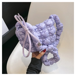 Detail of lavender pleated bag with adjustable bow shoulder strap and bubble texture