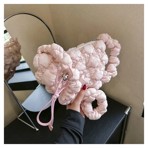 Detailed close-up of light pink ruched cloud bag with quilted texture and soft top handle