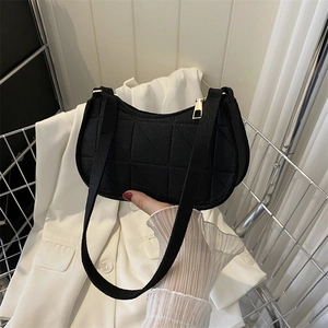 Minimalist black quilted felt underarm shoulder bag with geometric stitching and gold zipper