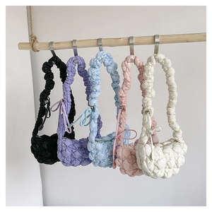 Detailed view of lightweight quilted cloud bags hanging in five pastel and neutral colors