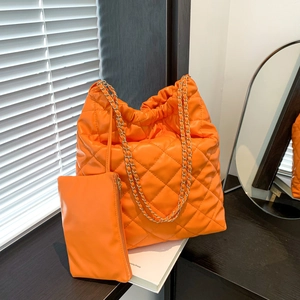 Bright orange quilted chain bucket bag set with matching pouch and golden metal strap