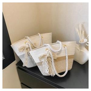 Detail of hand-woven cotton rope tote bag with lace bow decoration and gradient design