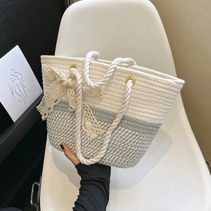 Woven tote bag with silk scarf bow accent and stylish dual-tone summer beach design