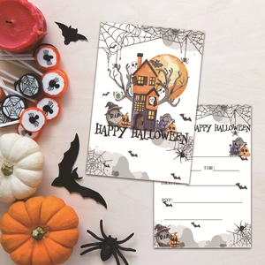 Close-up of Halloween party invitations with haunted house, pumpkin, and bat motifs