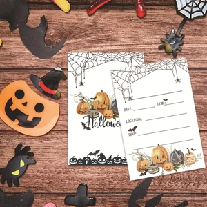 Detailed view of Halloween invitations with pumpkin illustrations on wood background